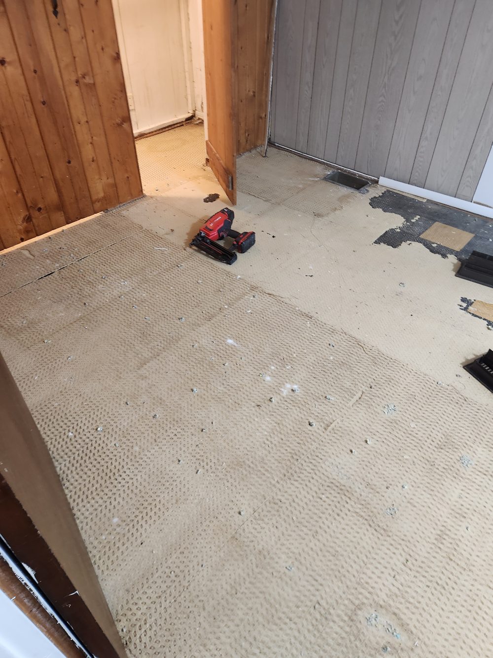 Before: bedroom subfloor before new carpet