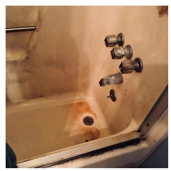 Before: grimy tub surround and fixtures