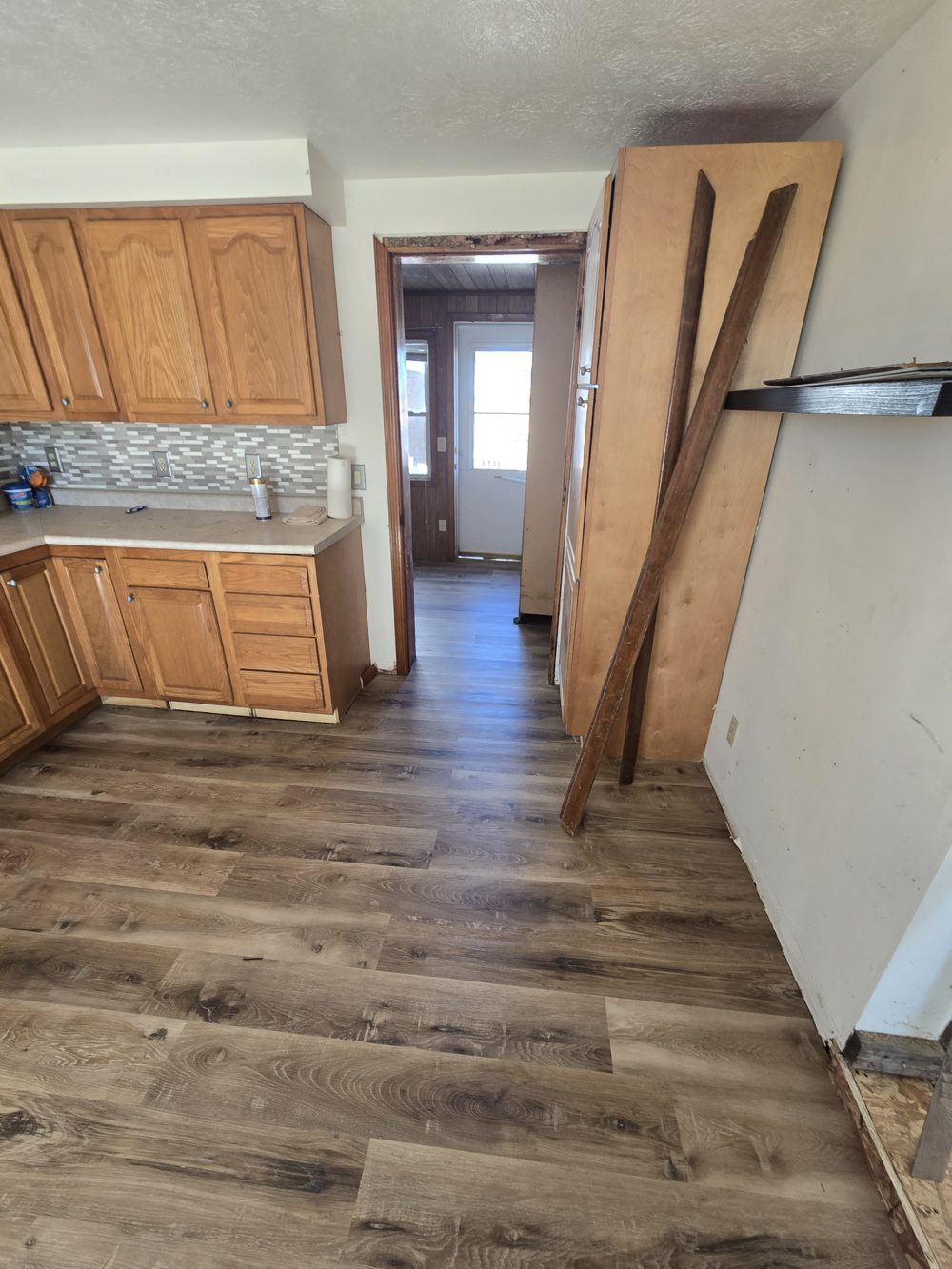 After: finished kitchen with new plank flooring