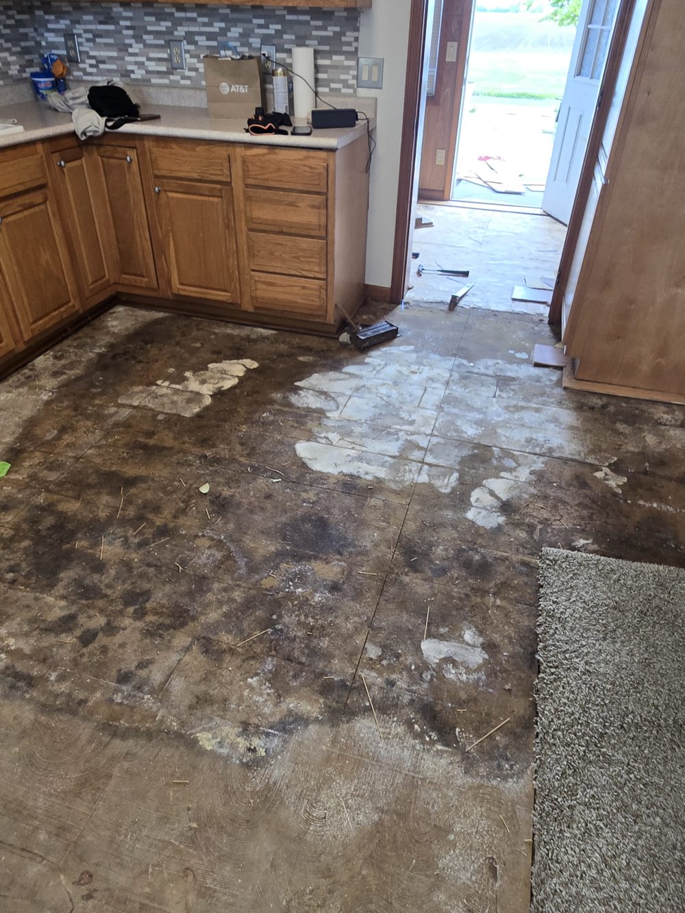 Before: kitchen subfloor during turnover