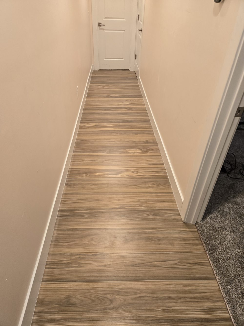 After: hallway with new plank flooring