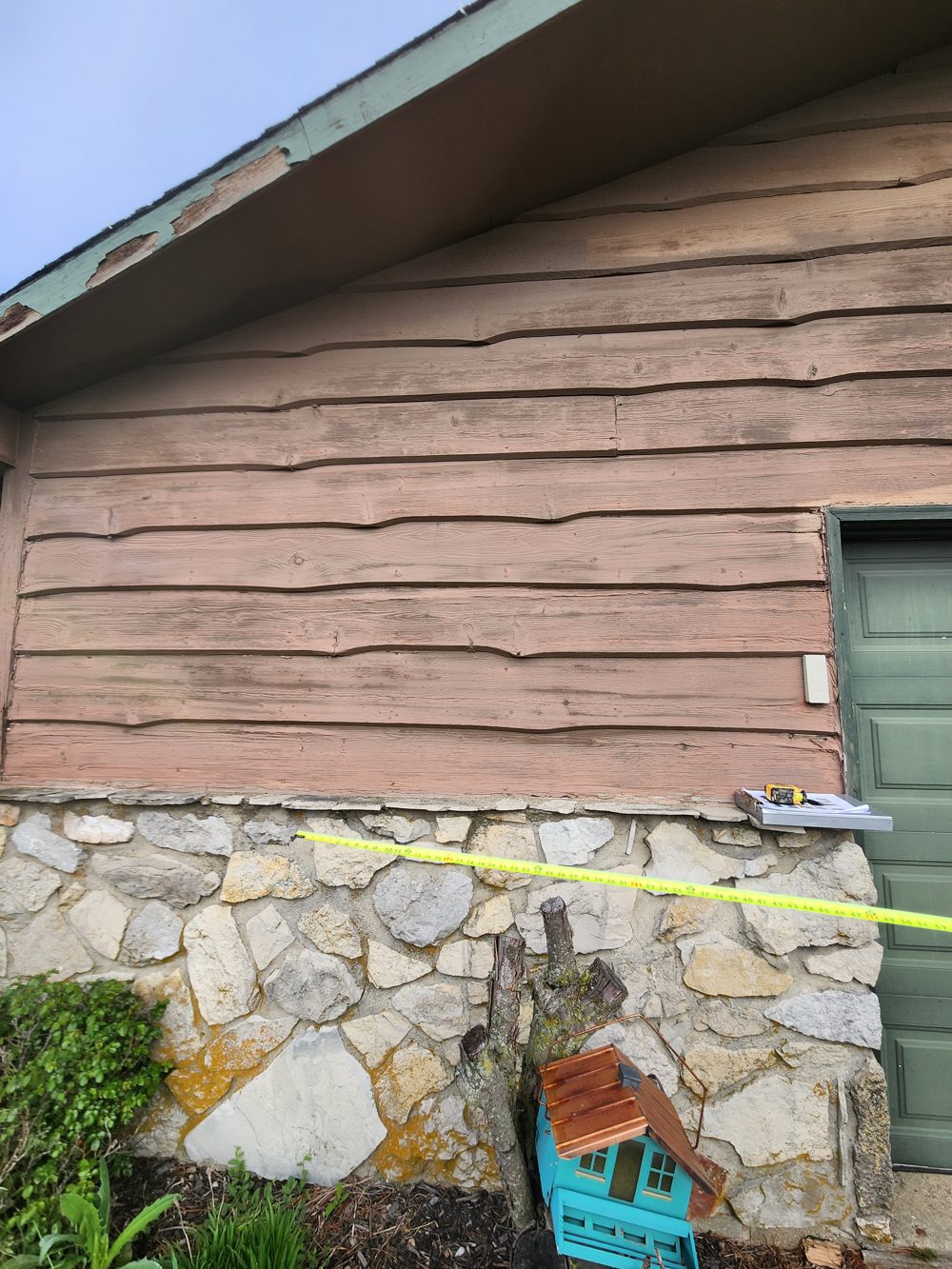 Before: worn wood siding, section 1