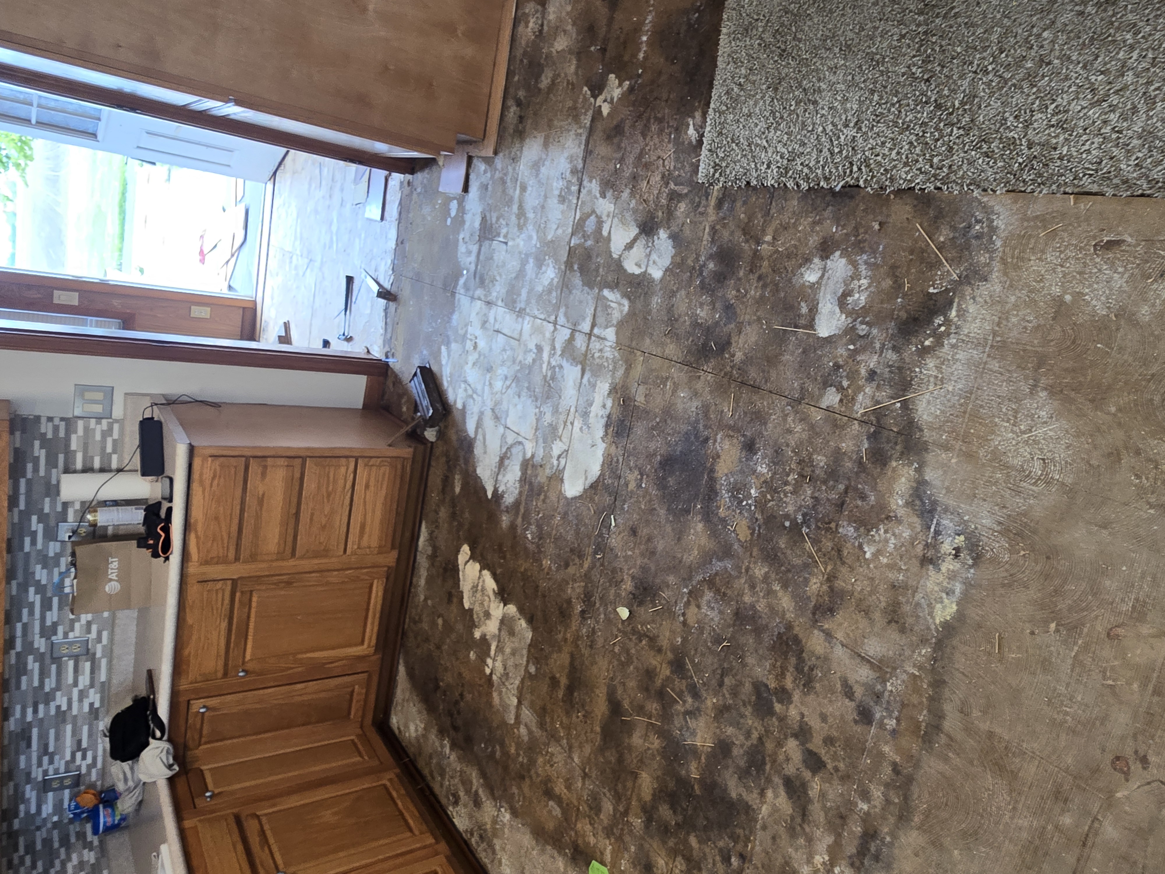 Before: bare subfloor during kitchen turnover